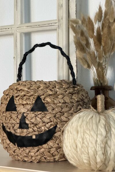 Basket with a leather pumpkin face.