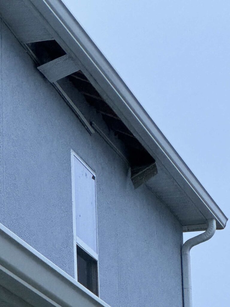 A house with missing soffits. 