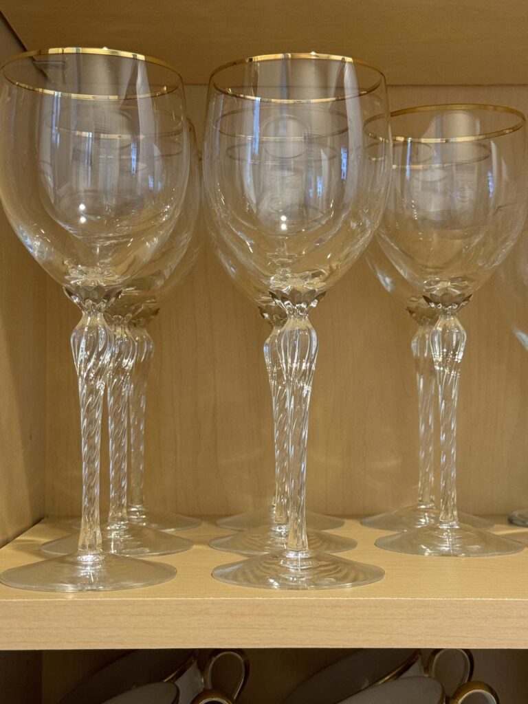 Crystal wine glasses stored in a cabinet in a butler's pantry. 