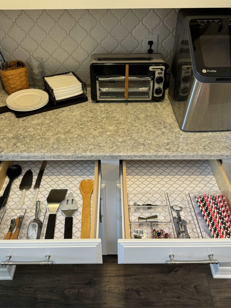 Two organized drawers in a butler's pantry. 