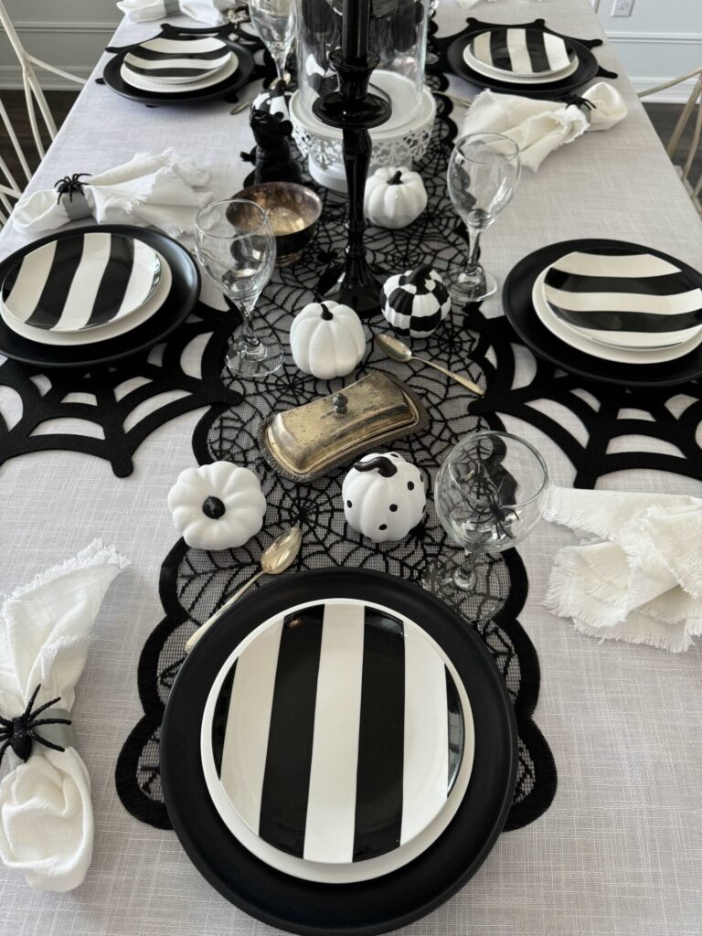 Halloween tablescape set with black and white items. 