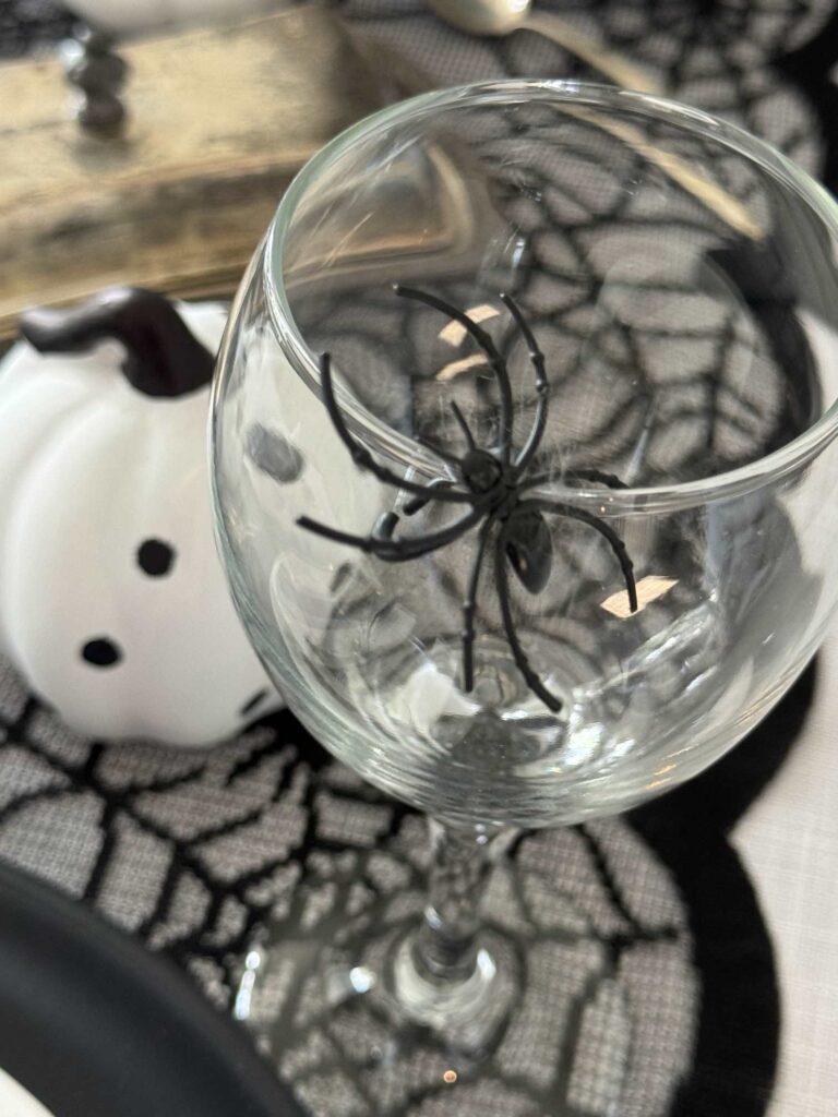 A spider on the rim of a wine glass. 