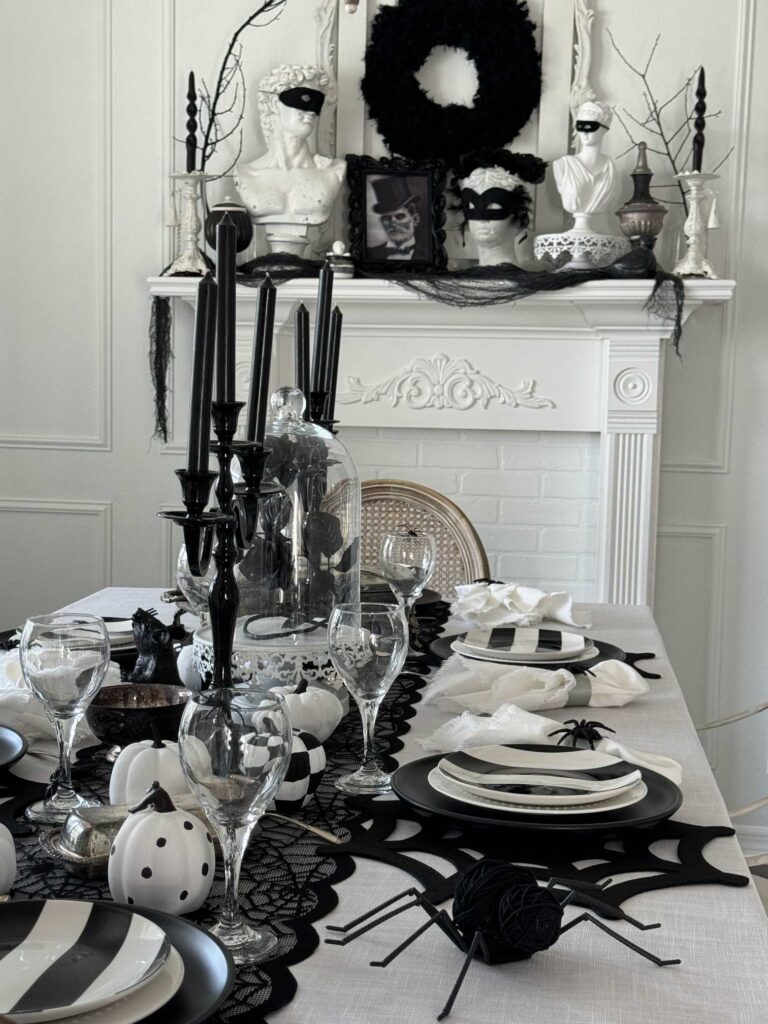 A dining room decorated for Halloween with black and white. 