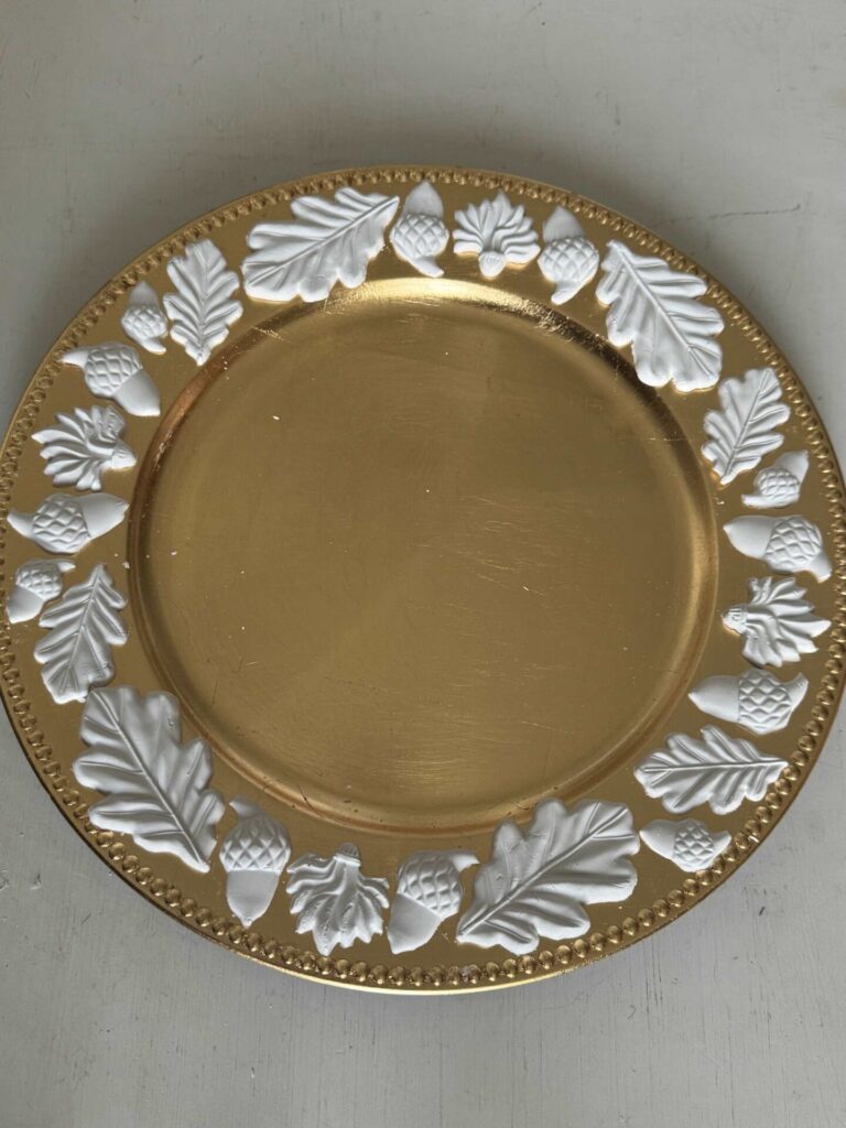 Air dry clay leaves and acorns on a gold charger plate. 