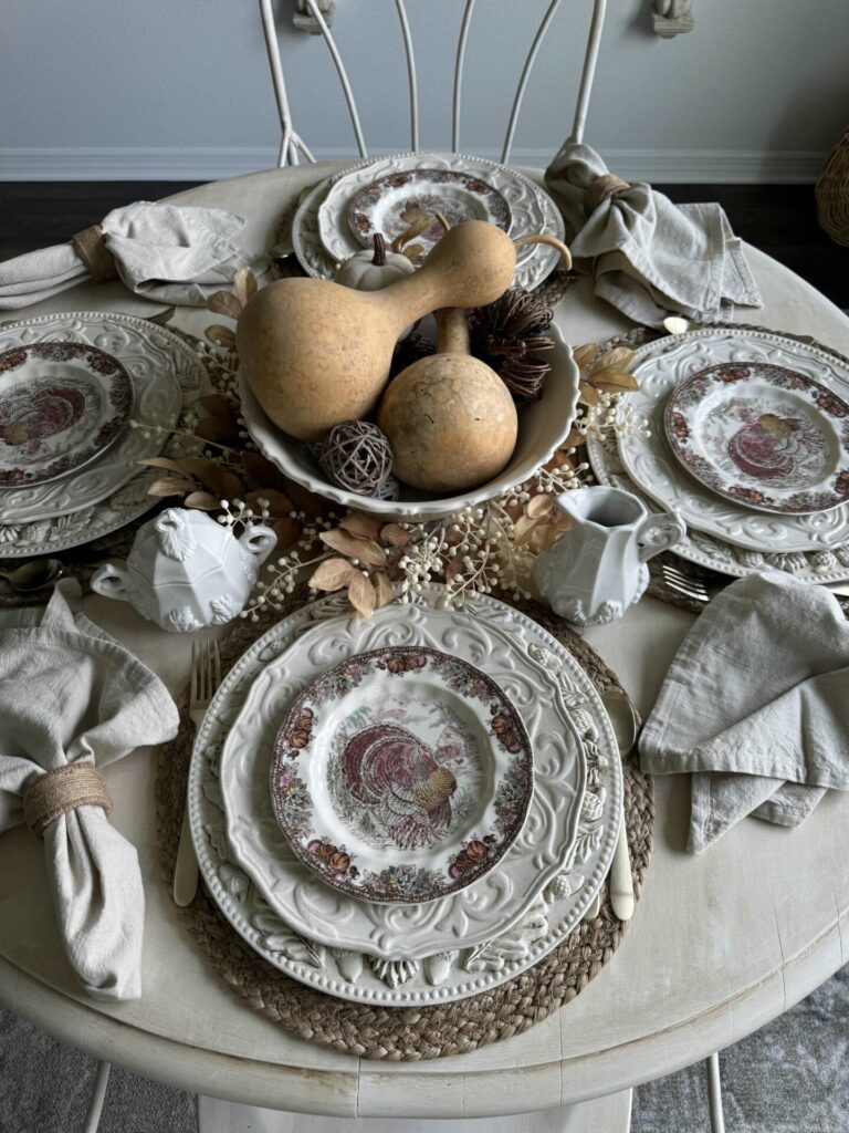 DIY charger plates stacked with dishes for Thanksgiving. 