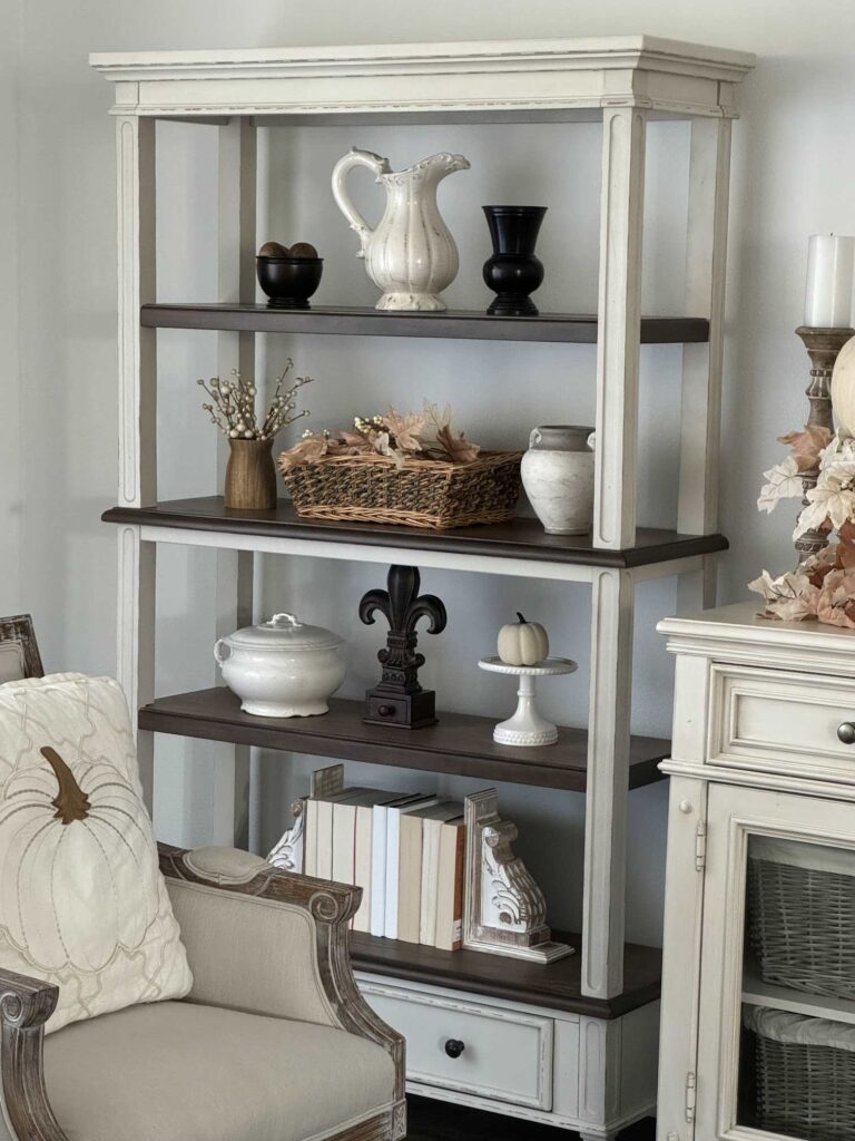 Shelves decorated for fall with brown and white items. 