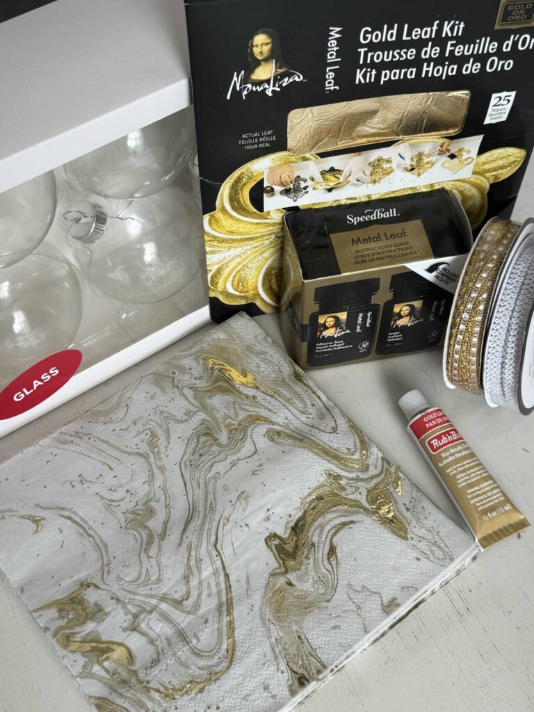 Learn how to gold leaf with a kit, glass ornaments, napkins, rub-n-buff, and ribbon. 