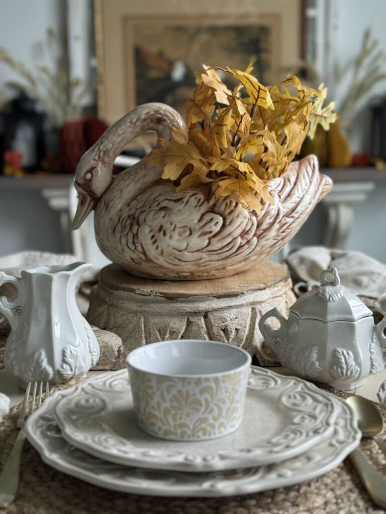 A swan planter filled with fall leaves. 