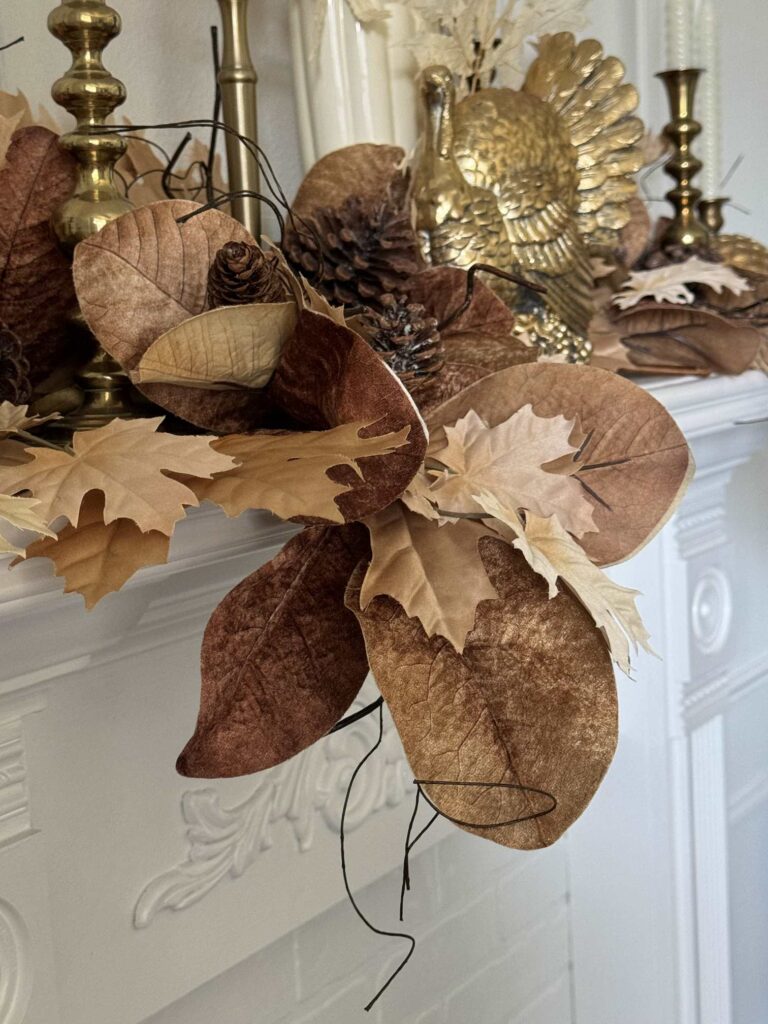 Brown leaf stems layered on a mantel for Thanksgiving. 