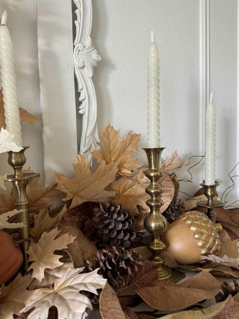 Gold candlesticks holding white twisted taper candles. 