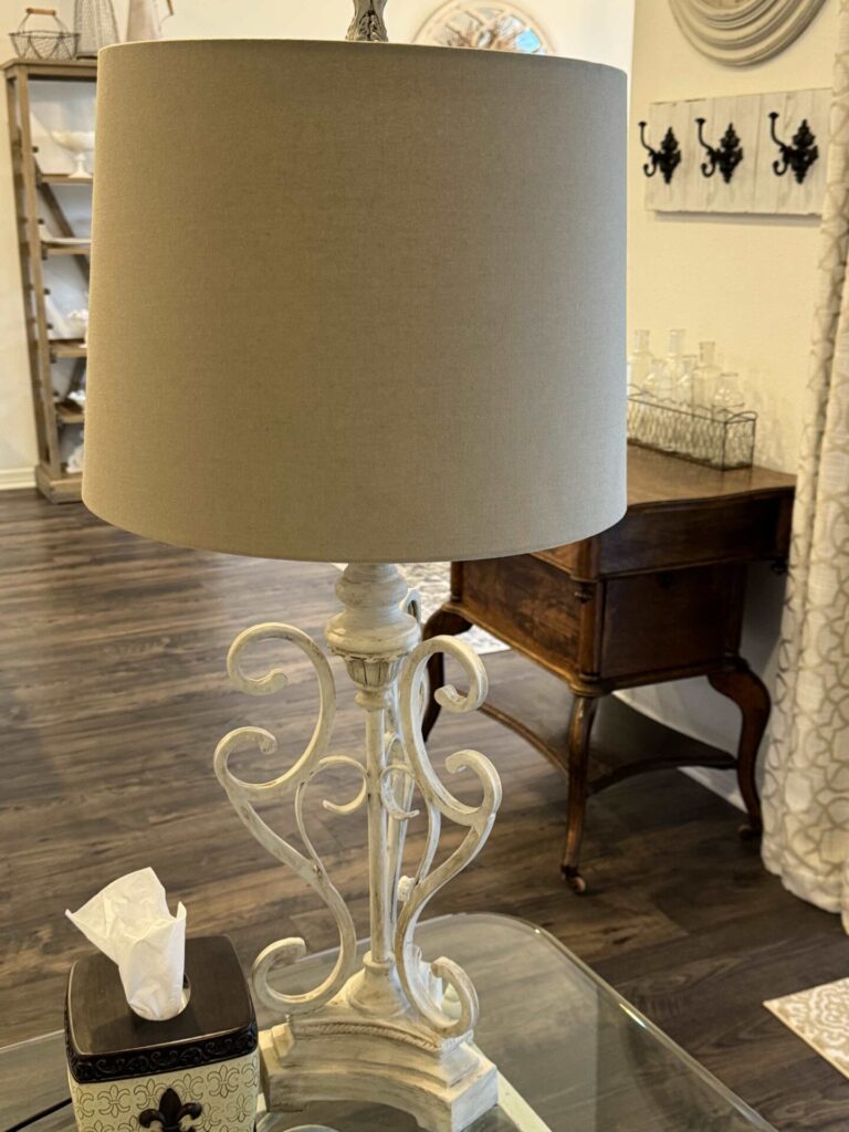 A lamp with a neutral lampshade.