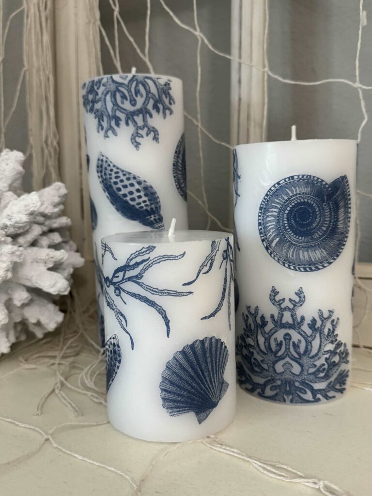 Three DIY seashell pillar candles. 