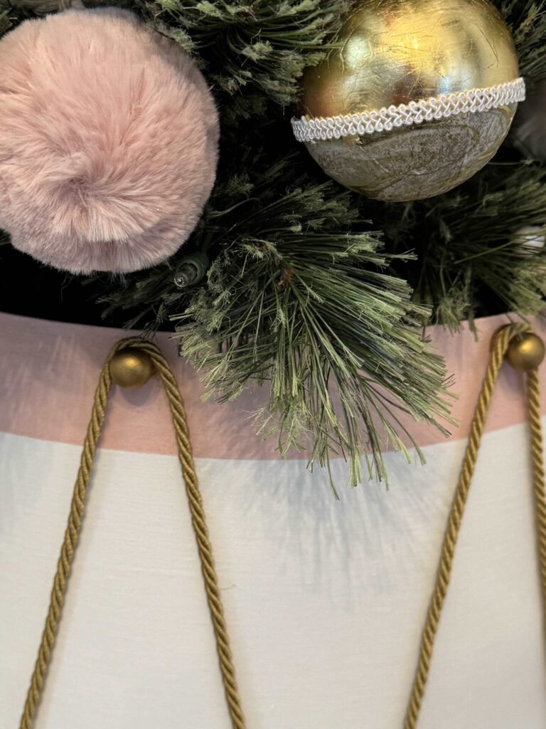 Gold and pink ornaments on a tree. 