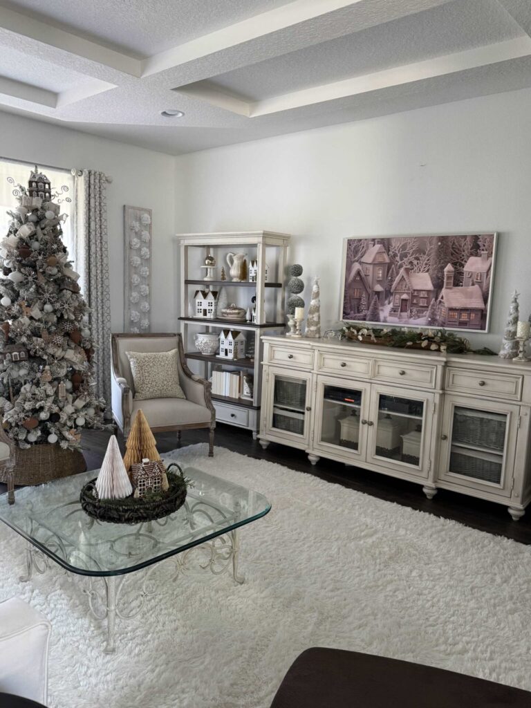 A living room with a white rug that's decorated with gingerbread Christmas decor. 