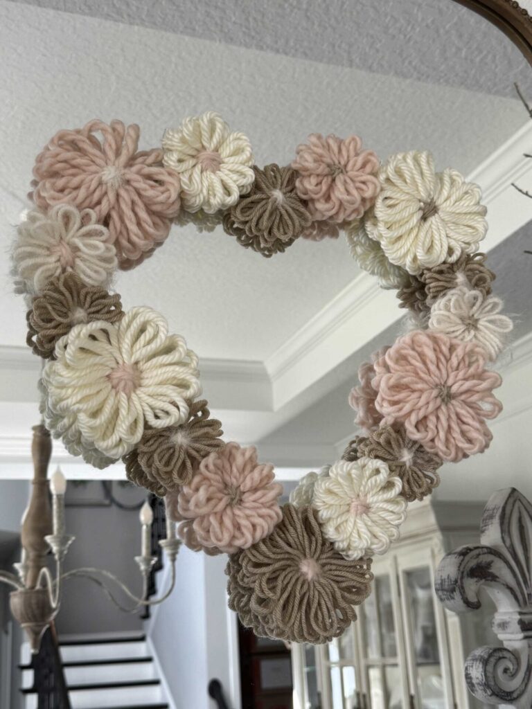 A DIY Valentine's Heart wreath hanging on a mirror. 