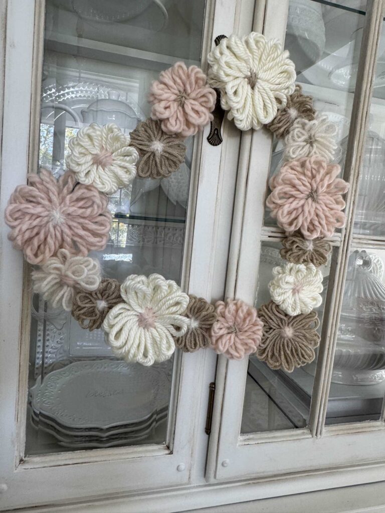 A DIY Valentine's Heart wreath hanging on a china cabinet door. 