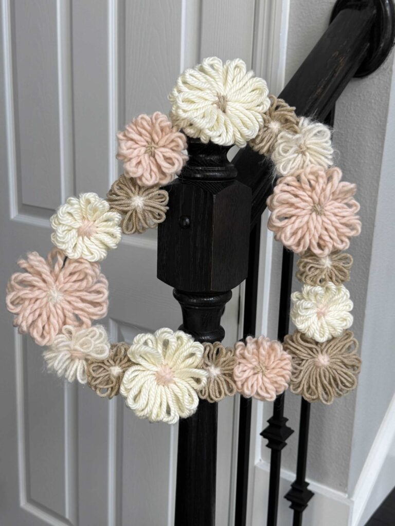 A DIY Valentine's Heart wreath hanging on a stair rail. 