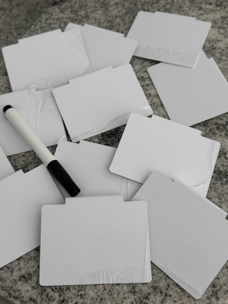 White labels and a black marker to write on them. 