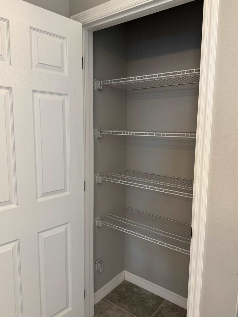 An empty bathroom closet ready to be organized.