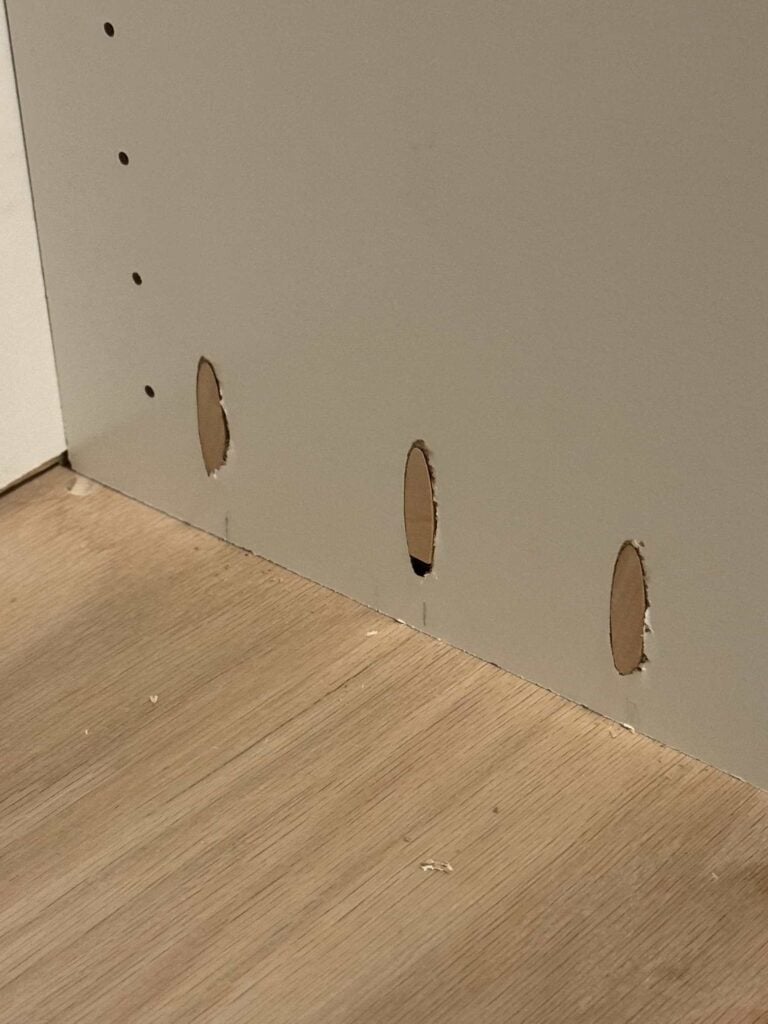 Pocket holes in bookshelf side closed up with pocket hole plugs