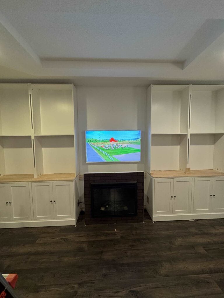 Four base cabinets and four bookshelves put together for an IKEA cabinet hack. 