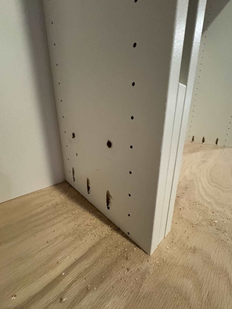 white shelf support with support screws and pocket holes drilled to attach shelf to oak countertop