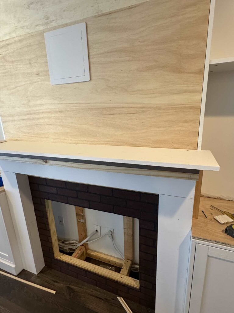 Construction of mantle showing multiple boards and top primed mantle board