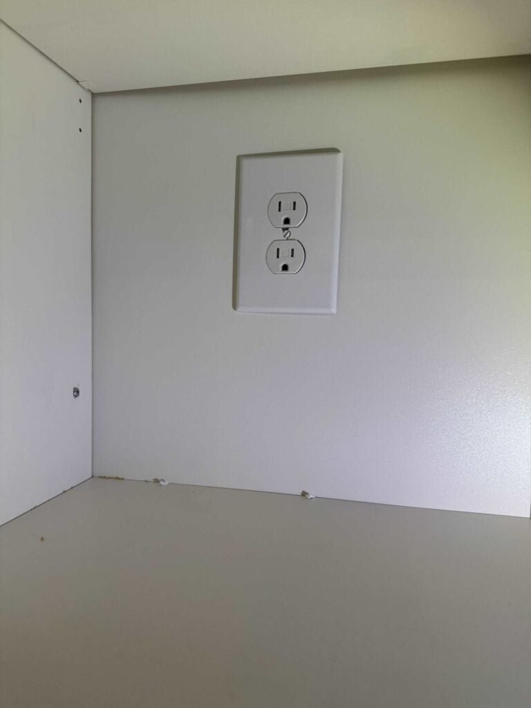 Outlet installed inside cabinet with faceplate mounted