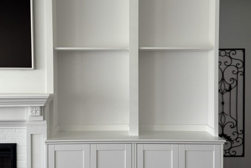 White built-in cabinets with bookshelves.