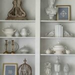 Living room book shelves decorated with blue and white thrifted items.