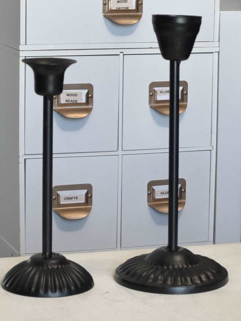 Two black candlesticks. 