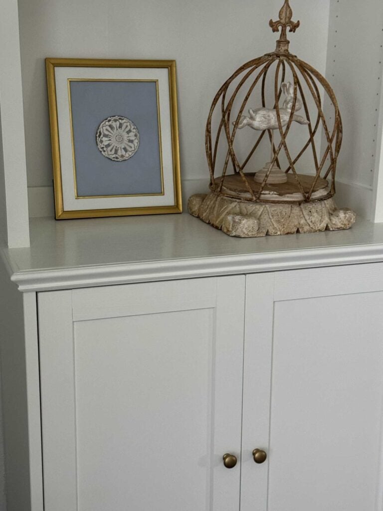 White cabinet with gold knobs.