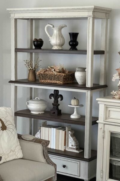 Bookshelves with brown and white decor items and books organized beautifully.