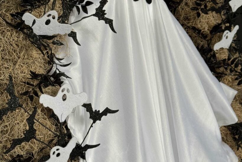 Spanish moss wreath with a large ghost in the center and small bats and ghosts surrounding it.