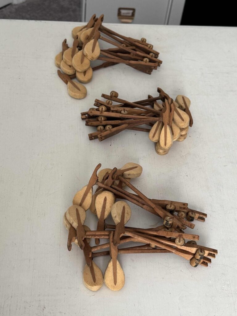 Three stacks of piano hammers. 