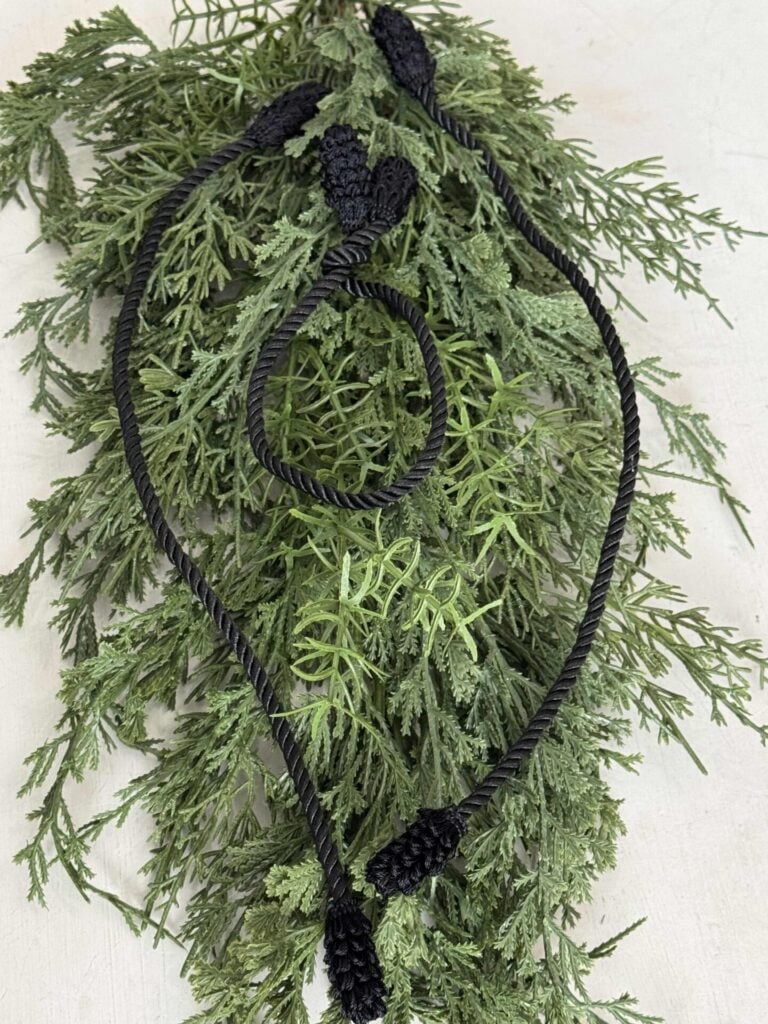Three black twist tie cords used to hang Christmas garland. 