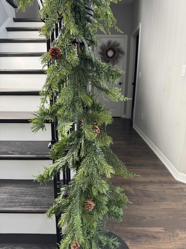 Evergreen garland on a stair rail. 
