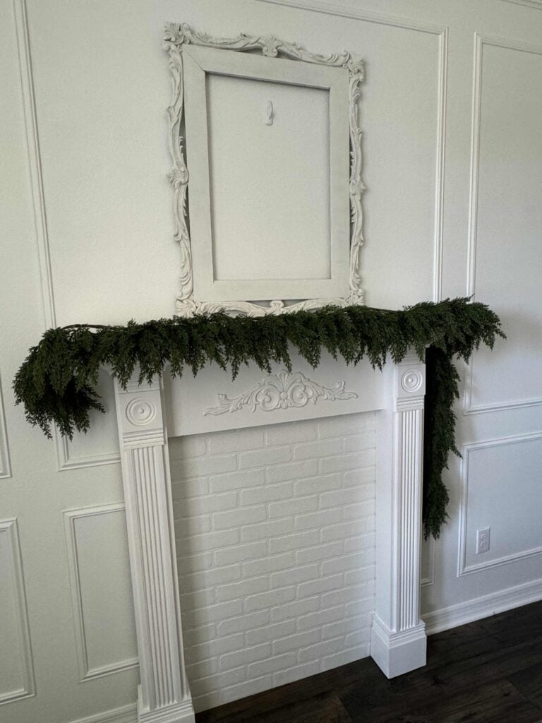 One garland hanging on a mantel. 