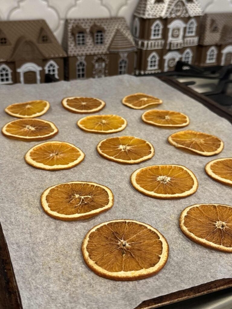 Dried orange slices on a baking sheet. 
