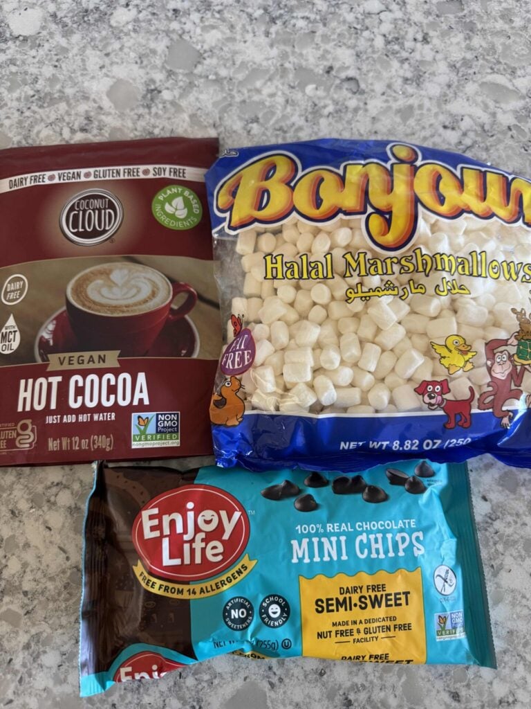 A bag of vegan hot cocoa mix, marshmallows, and mini chips. 
