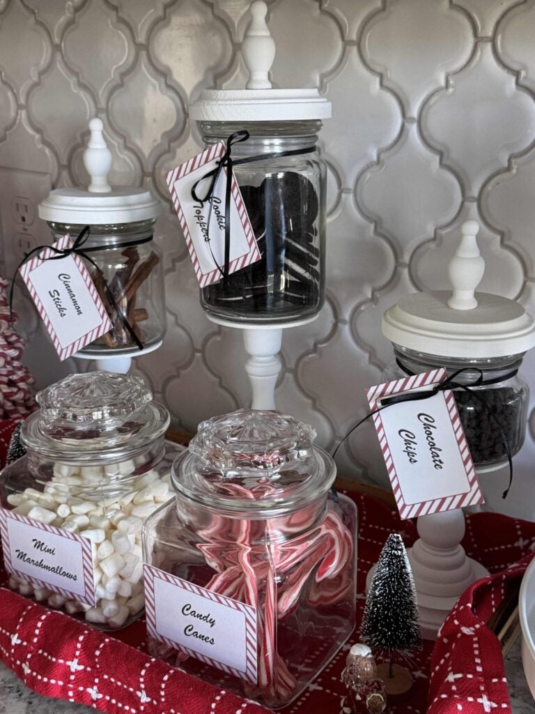 Hot chocolate bar toppings stored in lidded glass jars. 