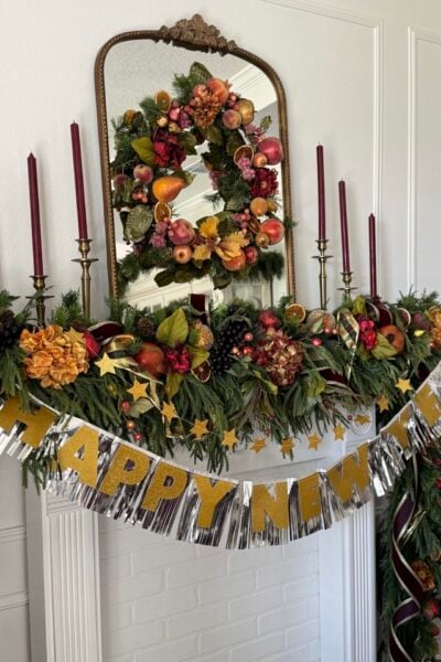 Mantel decorated for Christmas with a Happy New Year banner.