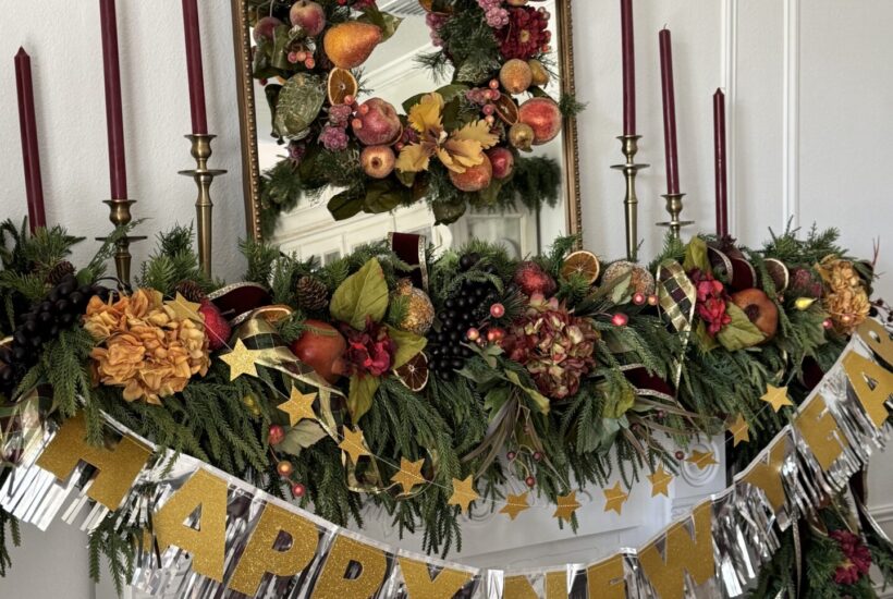 Mantel decorated for Christmas with a Happy New Year banner.