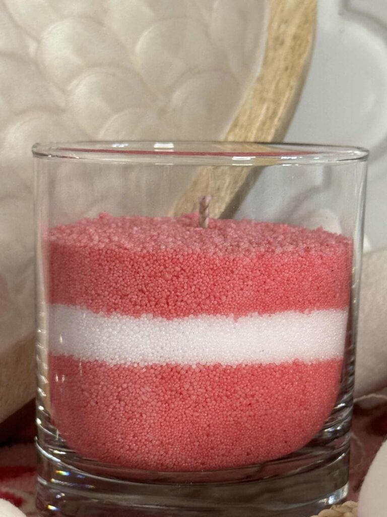 A DIY pink and white layered candle.