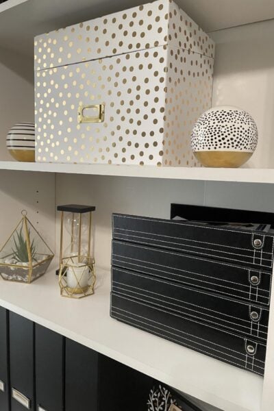 White shelves with black, white, and gold organizers.