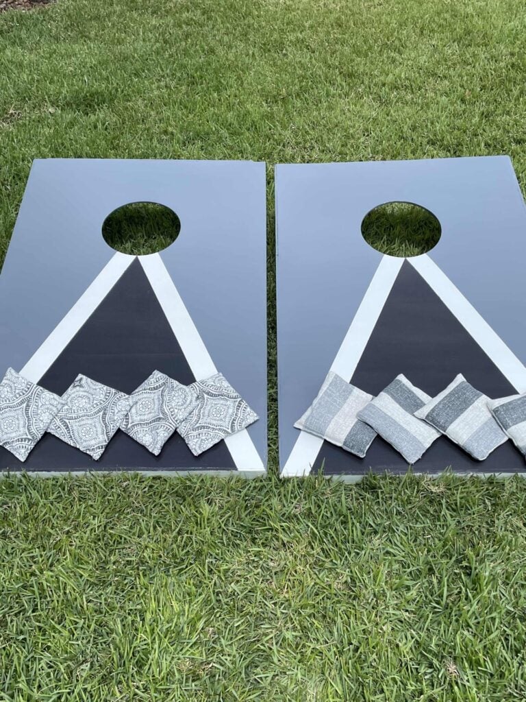 A cornhole set in a yard. 