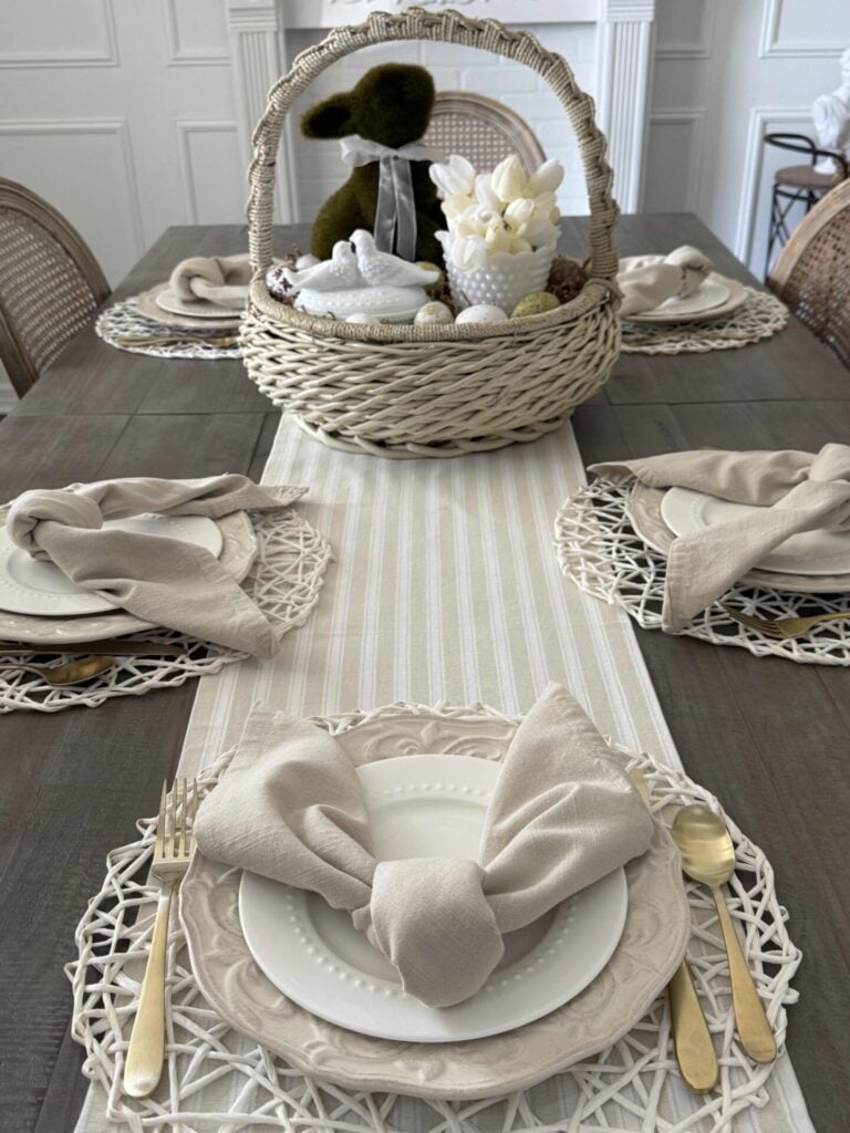 A DIY Easter centerpiece in a vintage basket on a table set for Easter. 