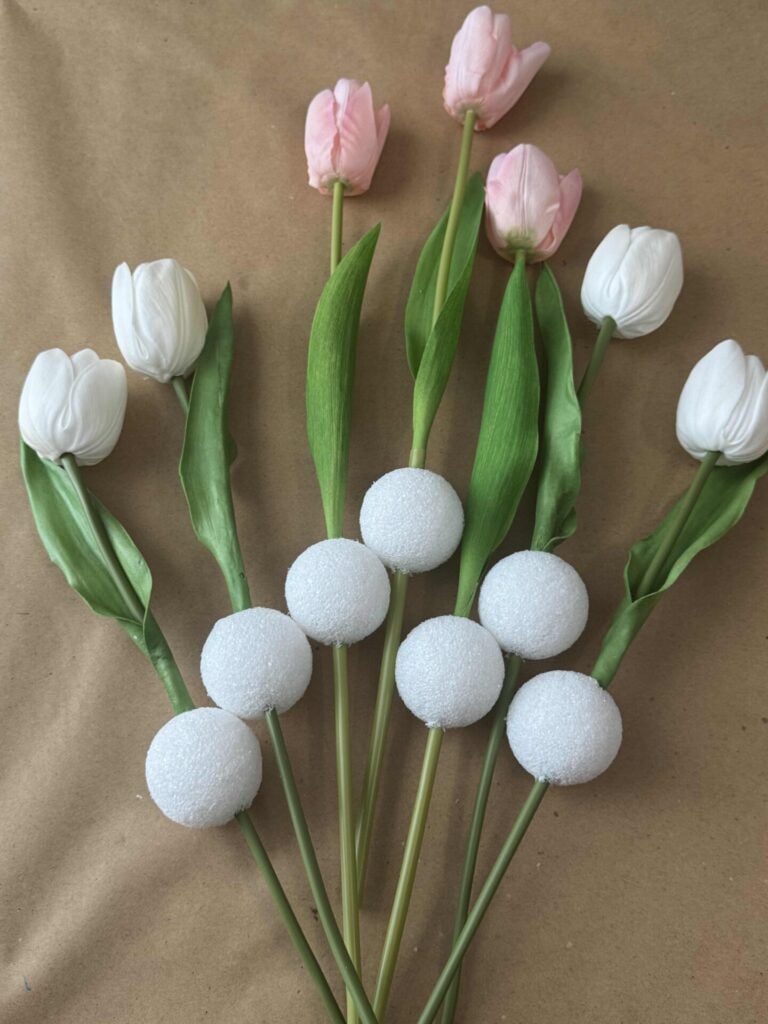 Faux tulips with a white foam ball pushed through each stem. 
