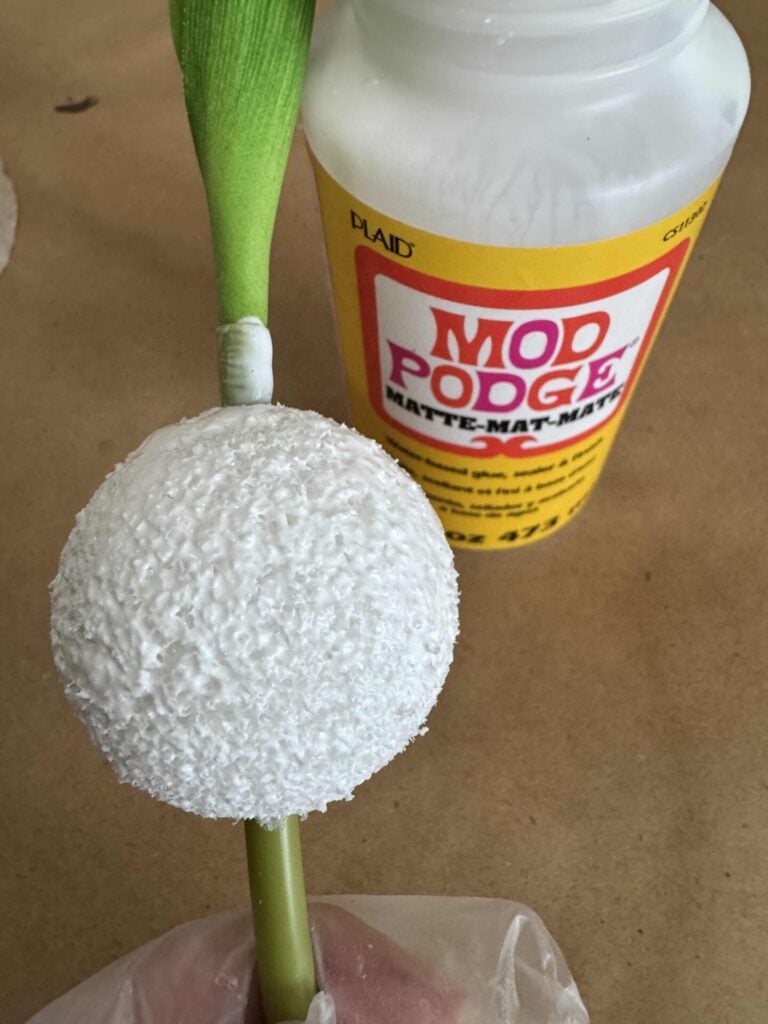 A foam ball on a tulip stem, painted with Mod Podge.