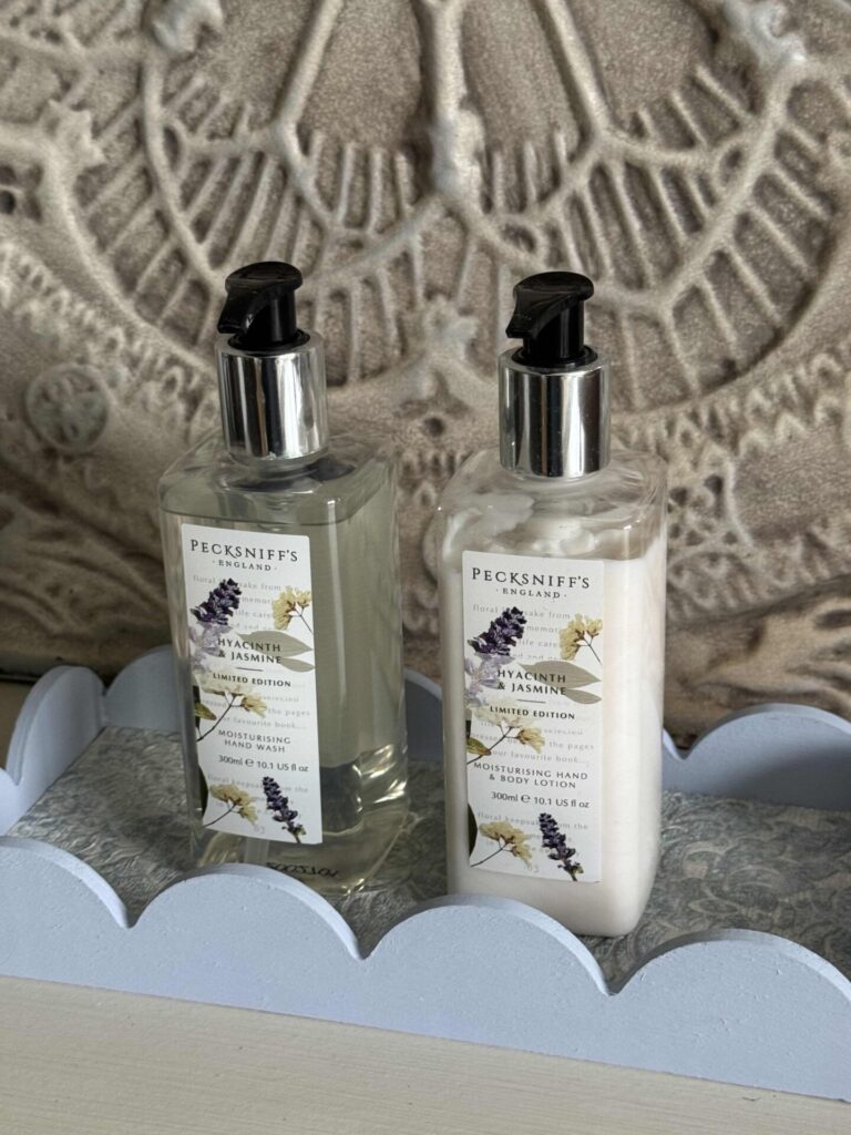 DIY tray lined with a wallpaper sample and holding a matching set of hand soap and lotion. 
